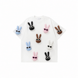 A soft white base that highlights the playful bunny colors — easy to style, effortless to wear.